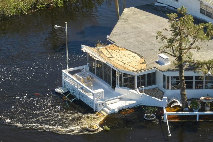 Hurricane Ian flooded houses in Florida residential area. Natural disaster and its consequences