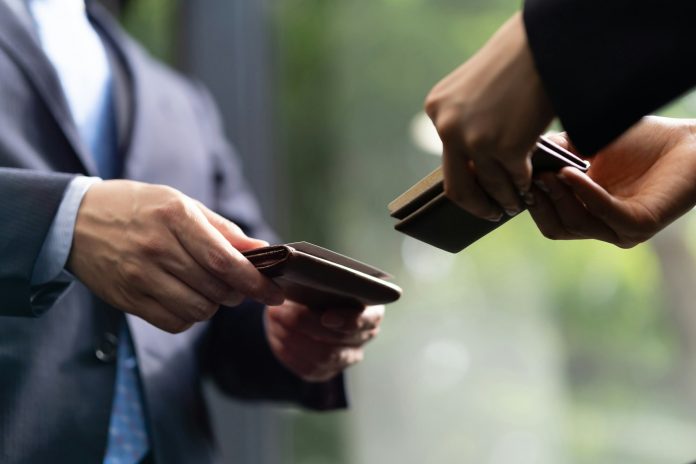 A close-up of a Japanese businessman exchanging business cards