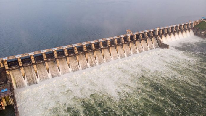 Aerial shot of large dam with foam water