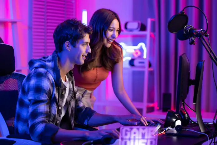 Caucasian Esport couple gamer playing online video game on computer.