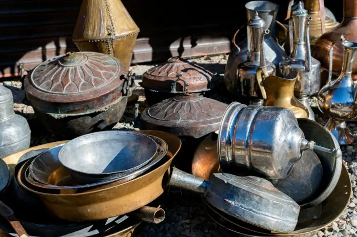 Close up of antique brass jugs and dishes