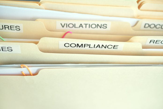 Compliance in the workplace. Folders labeled Compliance, Violations in focus.