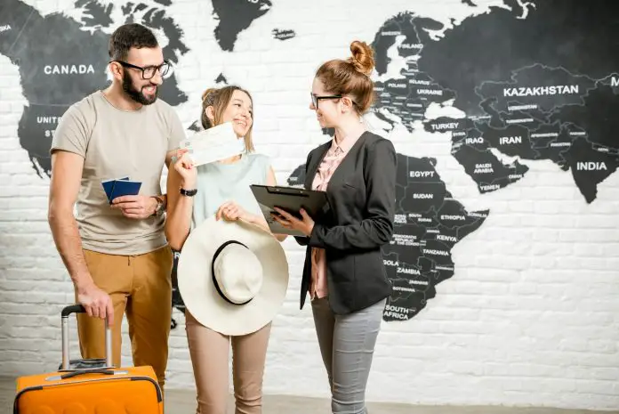 Couple with travel agent at the office