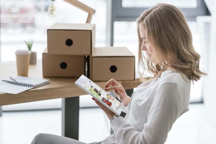 side view of young businesswoman using digital tablet