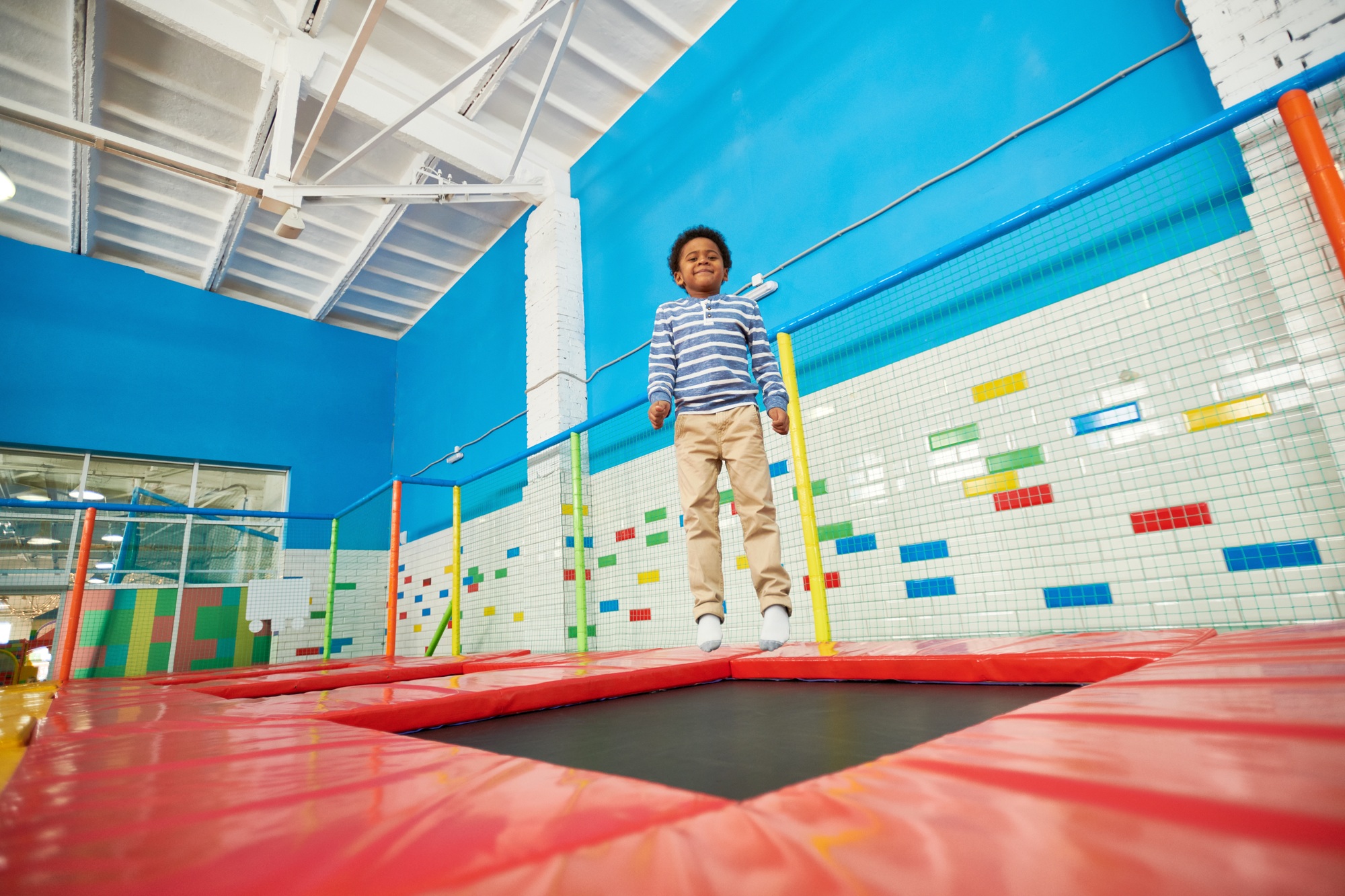 African-American Boy Jumping on Trampoline