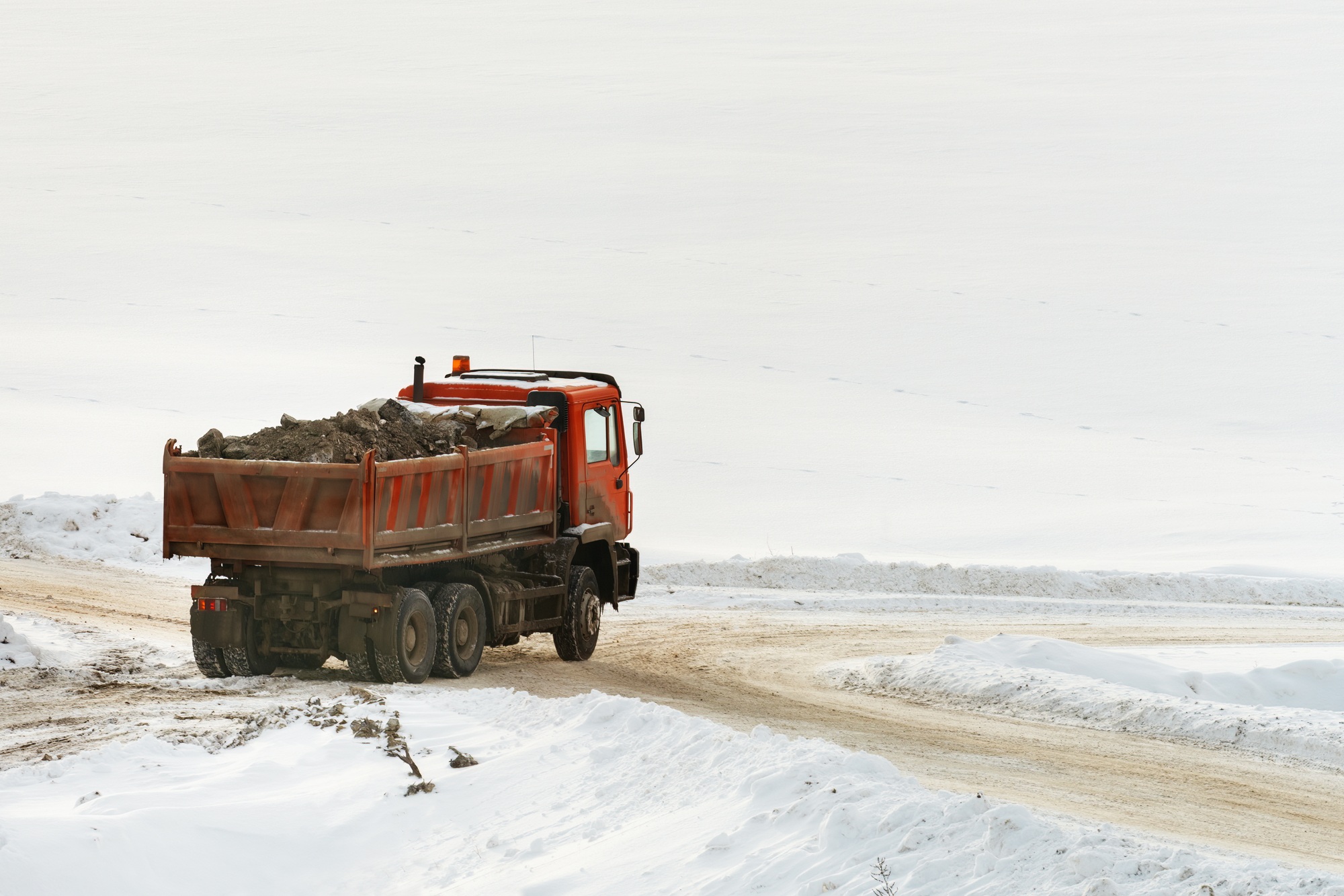 Construction truck loaded with rubble in winter