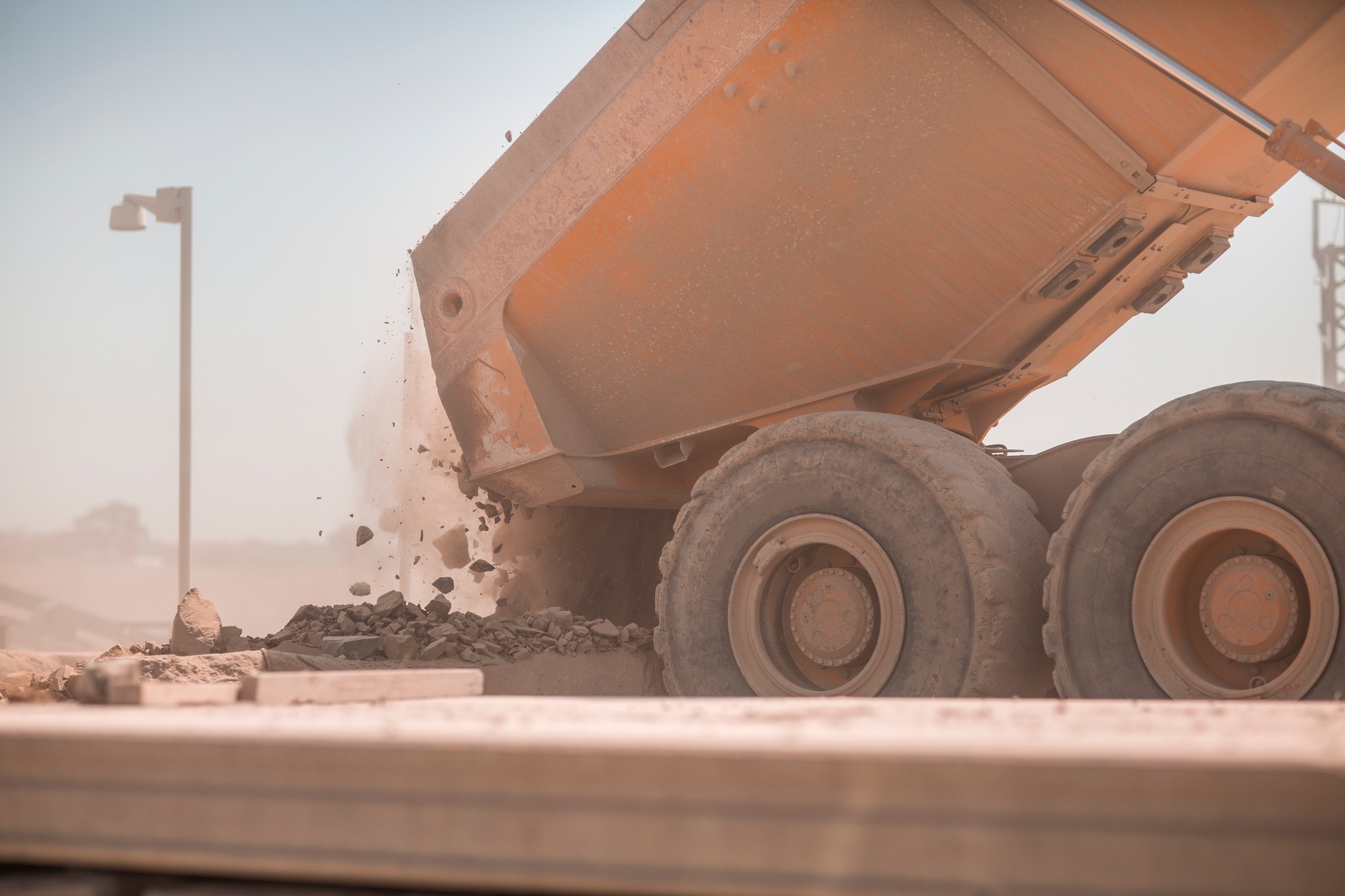 Dump truck unloading gravel at a construction site