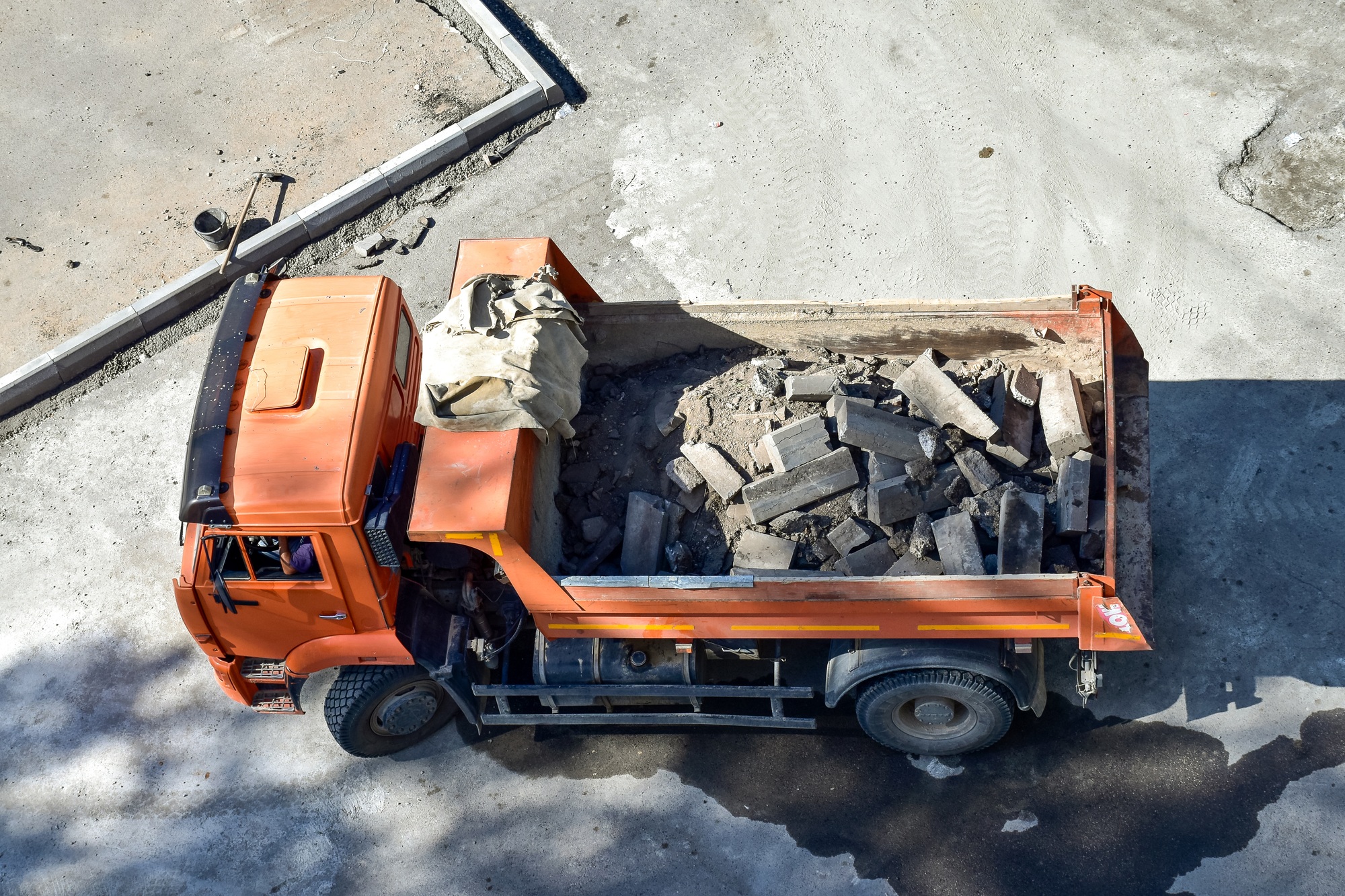 Heavy industrial dump truck .City road construction and renewal site