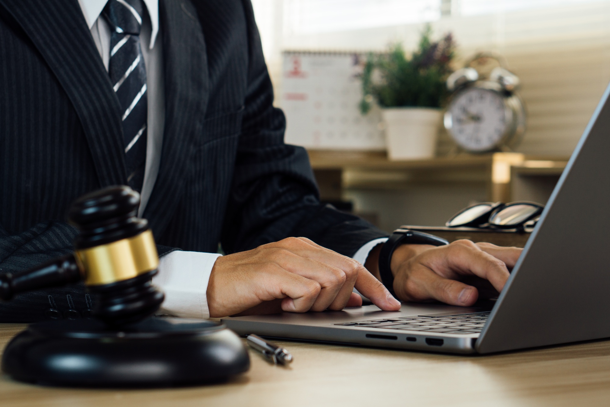 justice and law concept.Lawyers working on legal matters using laptop in office.