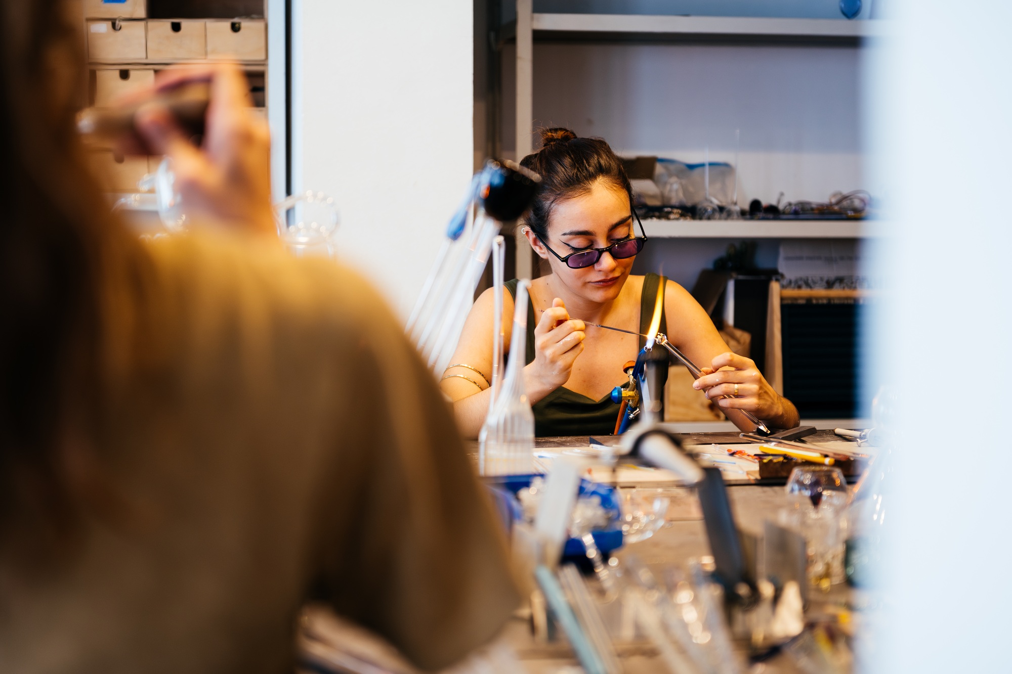 A Young Woman Immersed in Creating Elegant Crystal Jewelry in a Cozy Studio Setting