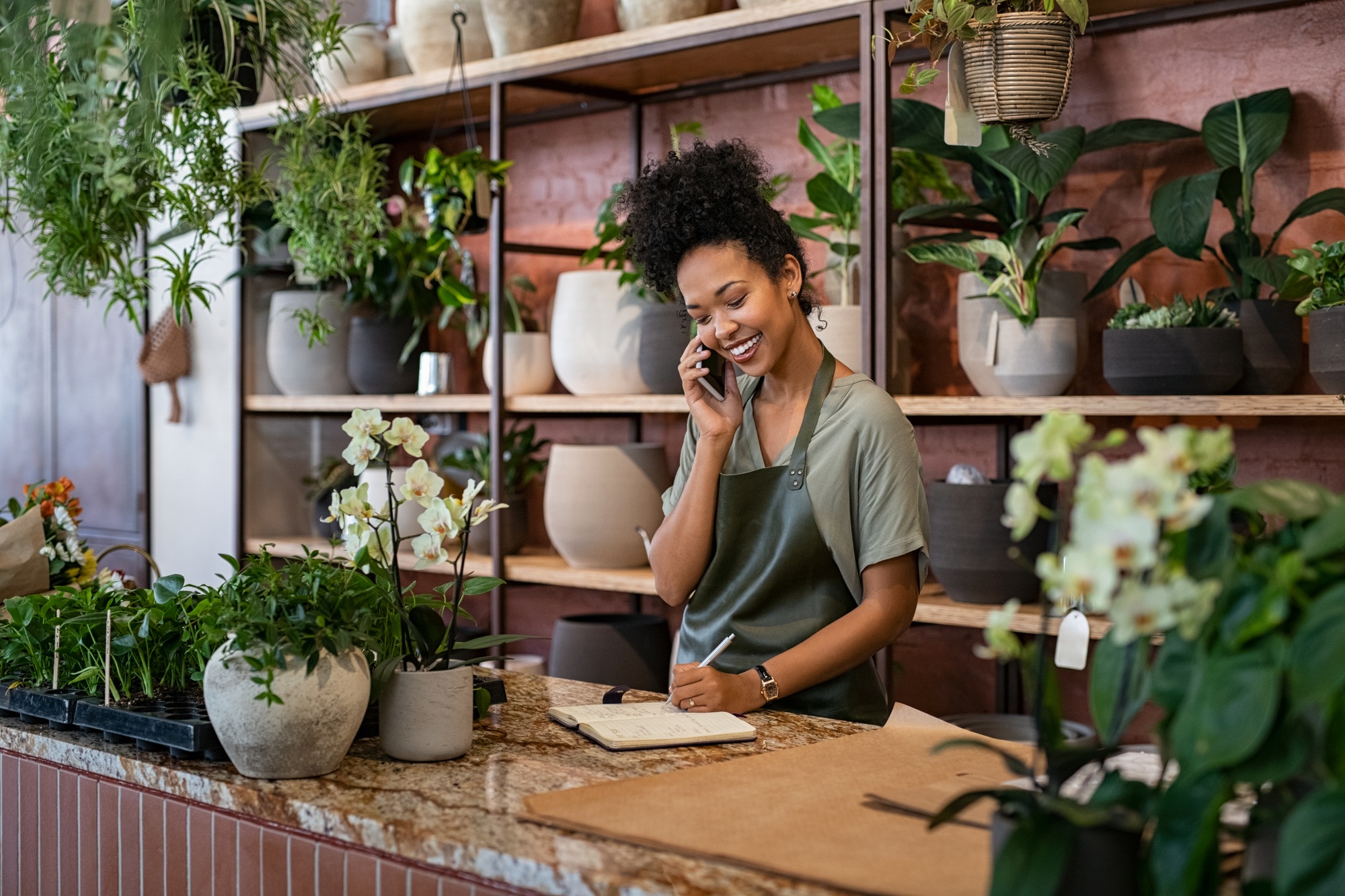 Florist takes an order on the phone at flower shop