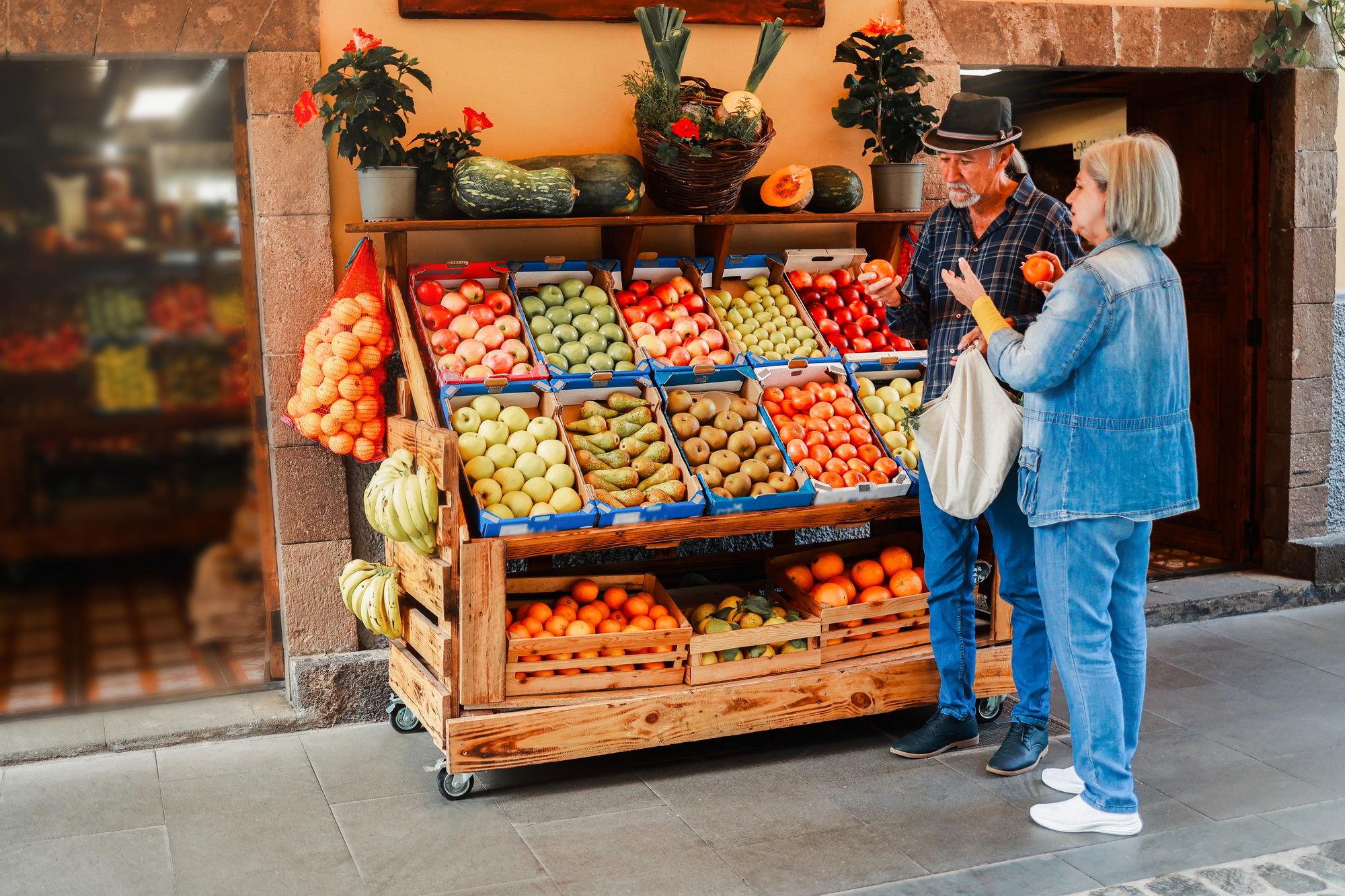 Senior couple shopping food at farm market. Customers buying at grocery store.