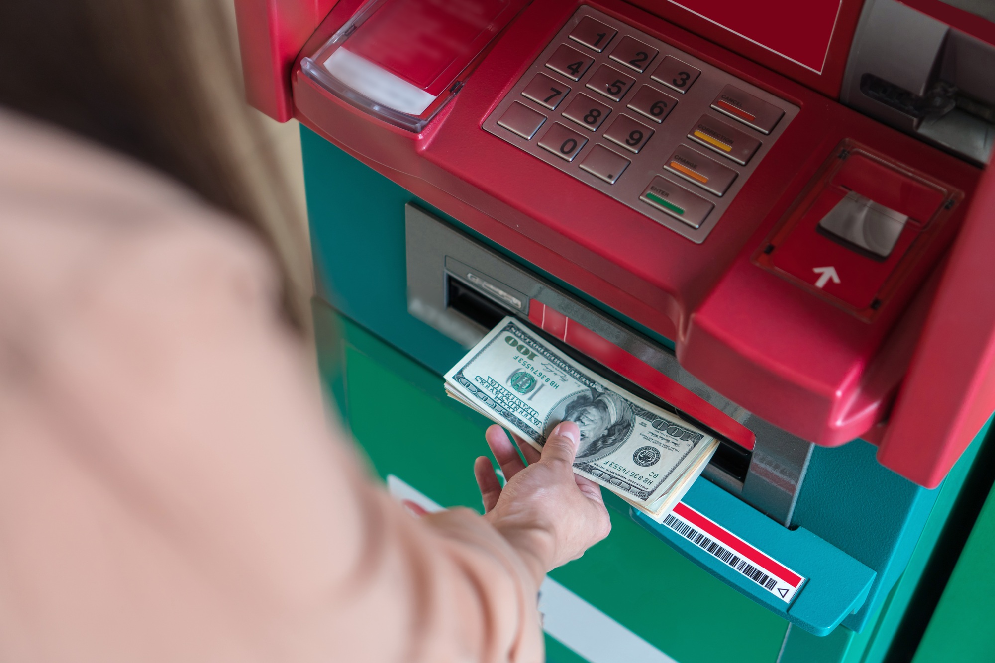 Top view of Closeup woman withdrawing the cash via ATM, business Automatic Teller Machine concept