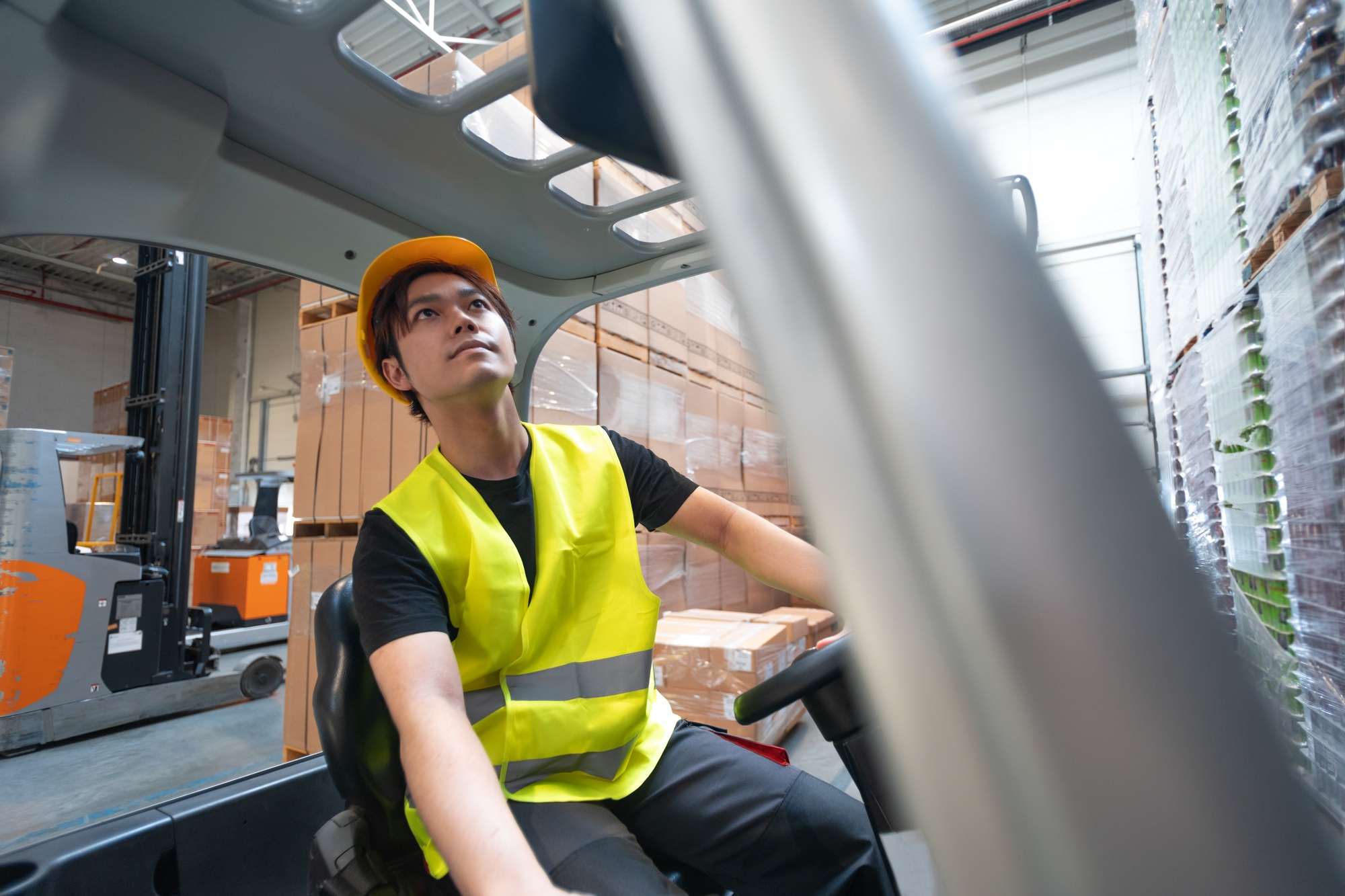 Warehouse worker operates a forklift