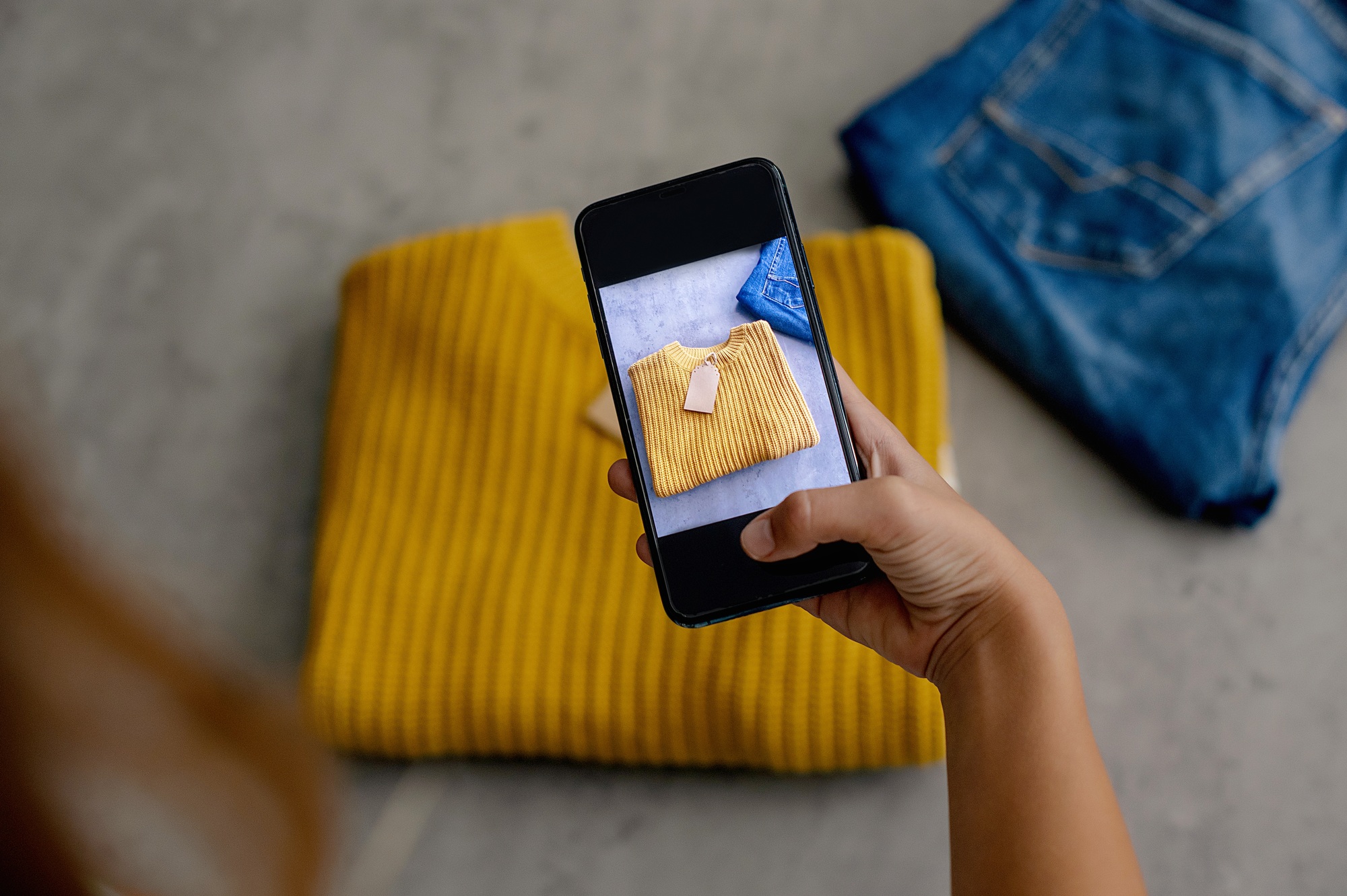 Woman taking photo of shirt on smartphone