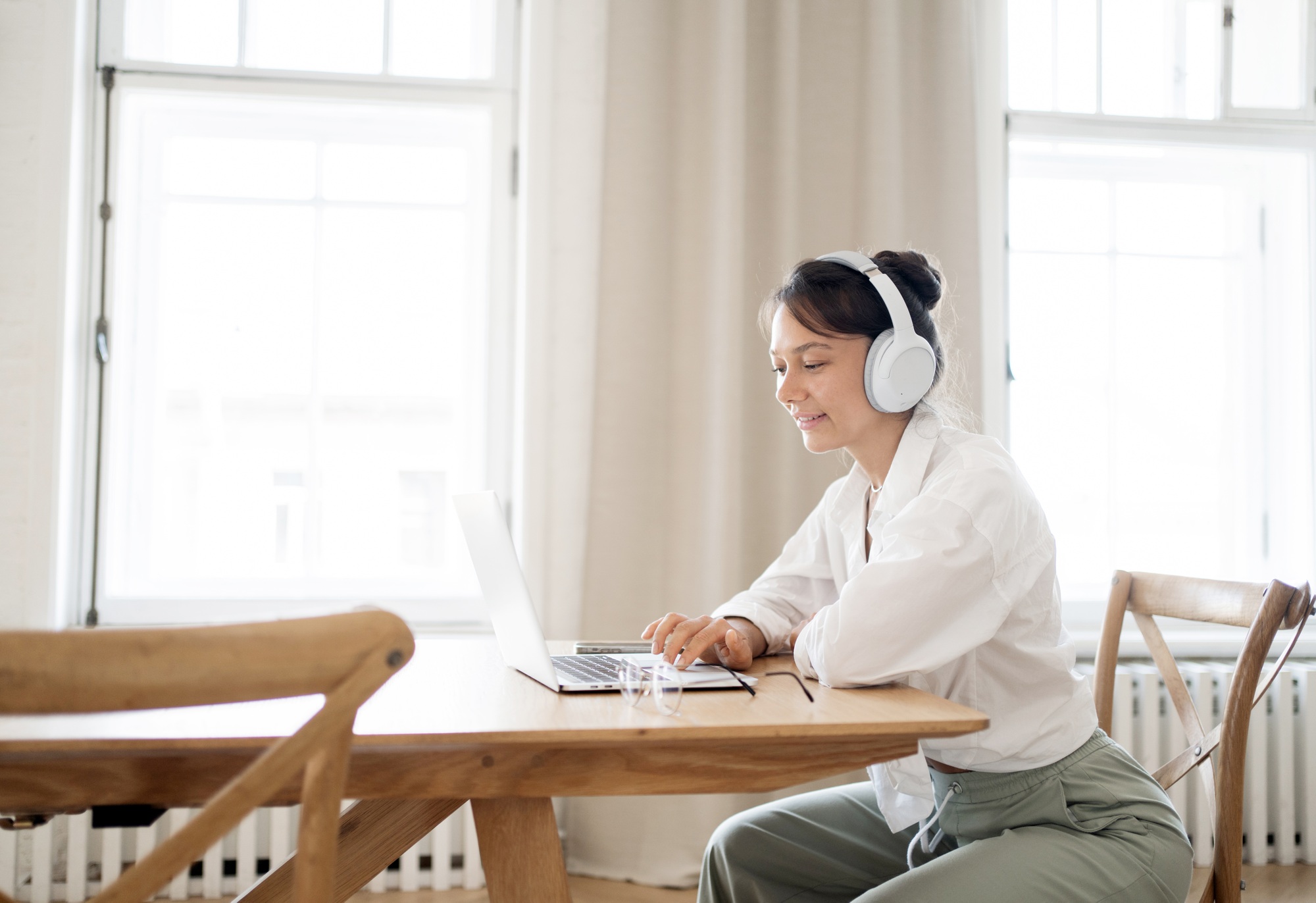 A female freelancer works in an office online doing a design project on a website.