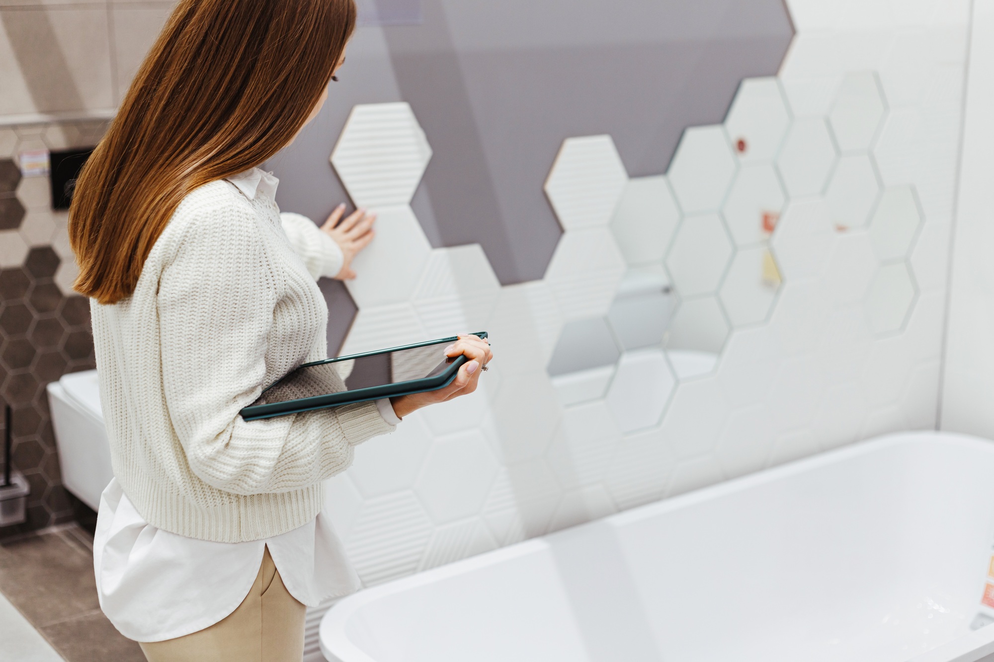 A woman specialist with a tablet checks the quality of work performed and compliance with the design