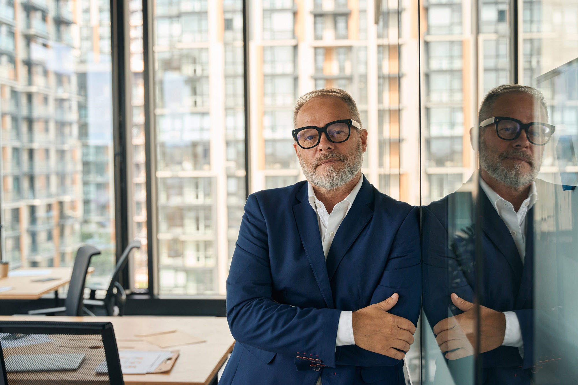 Accomplished businessman posing confidently at well-designed office