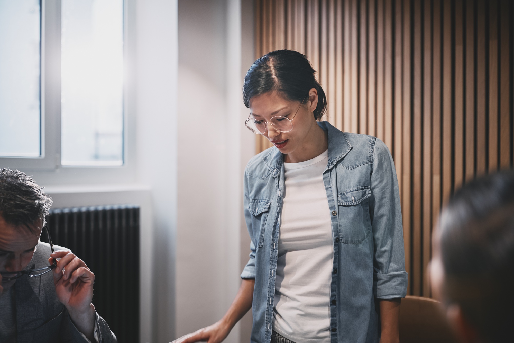 Businesswoman meeting with staff in an office boardroom