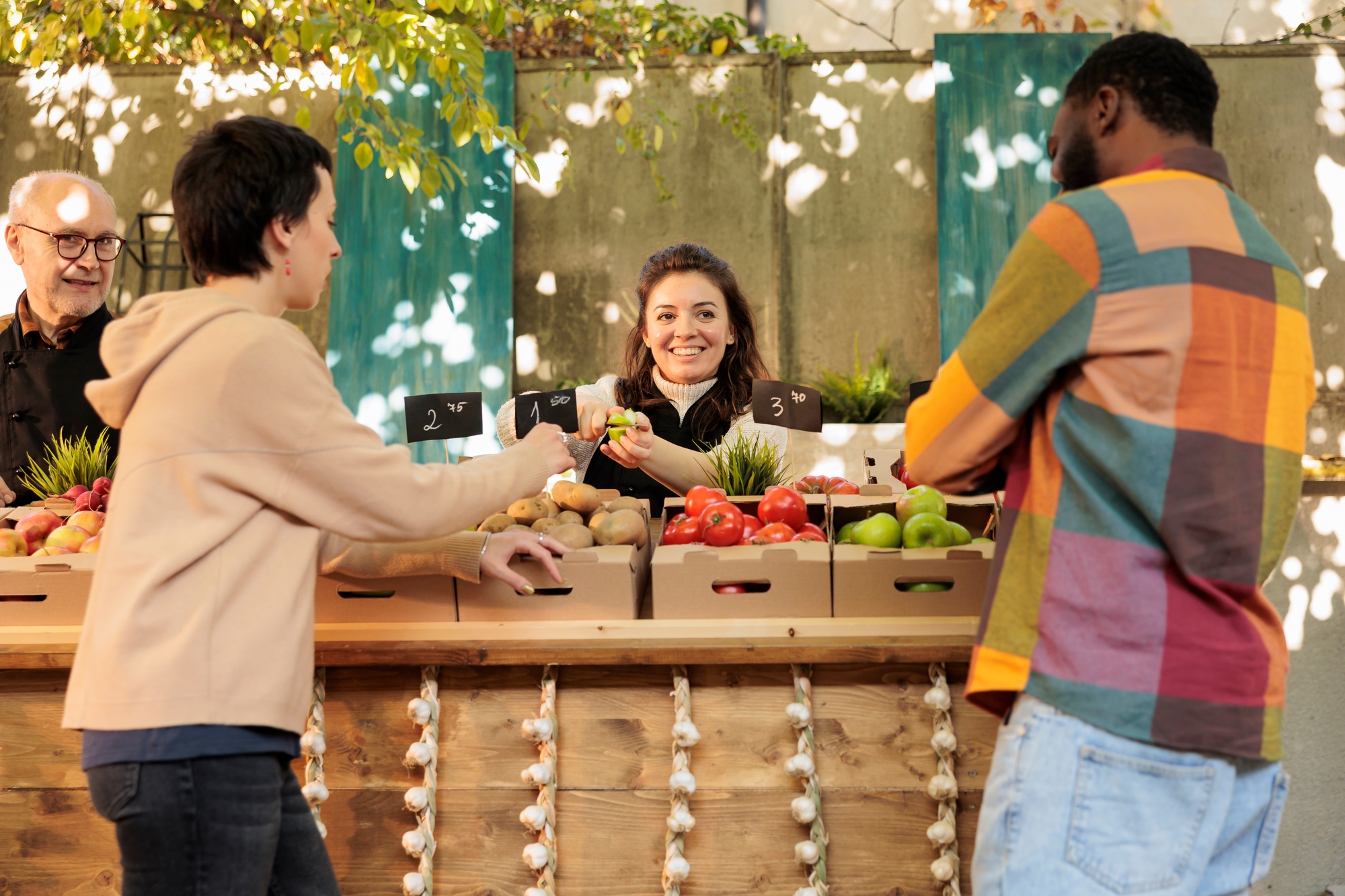 Friendly farmers market vendor offering free samples to costumers