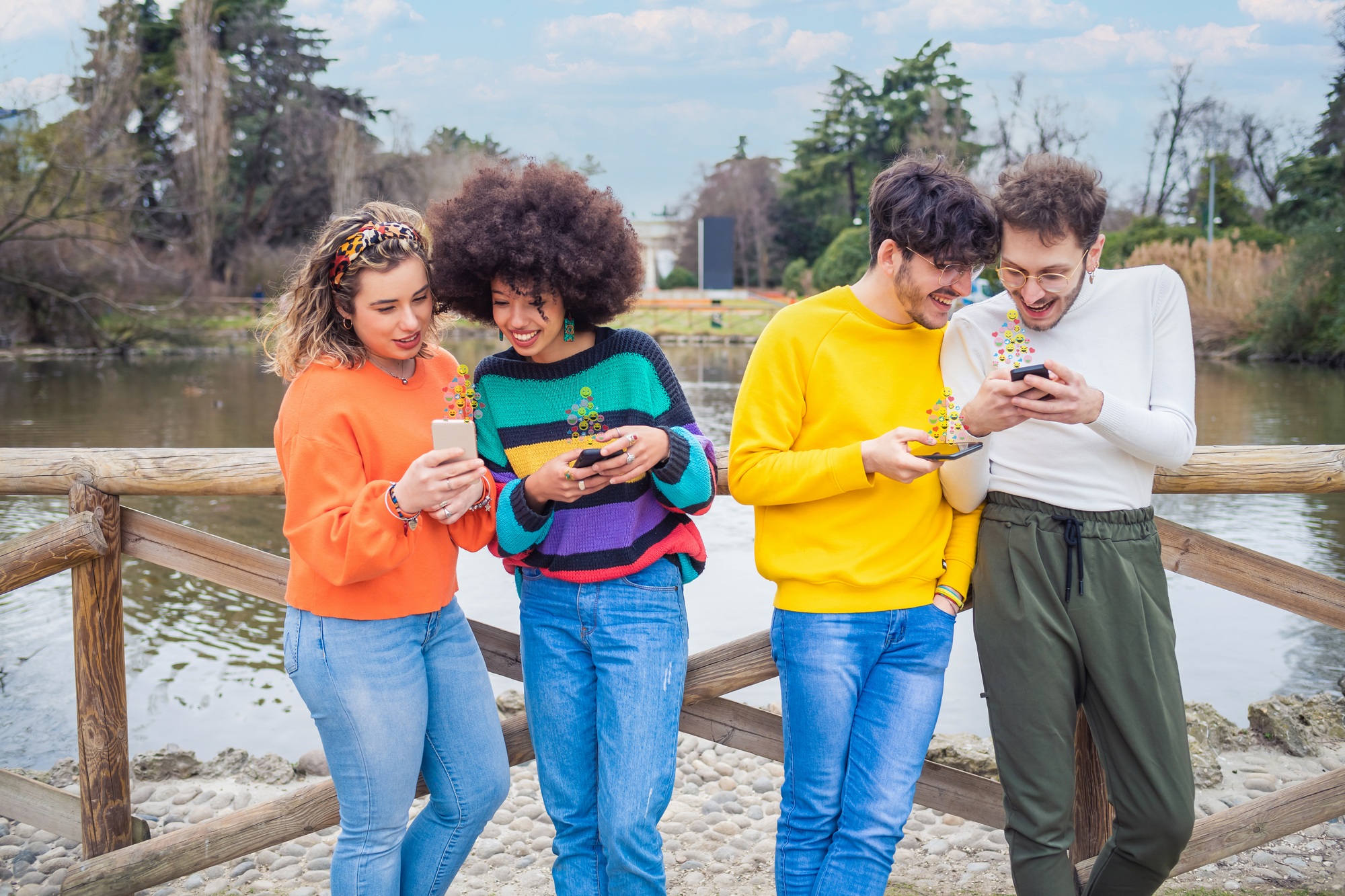 Group of multiethnic friends millennials using mobile phones addicted to viral trends