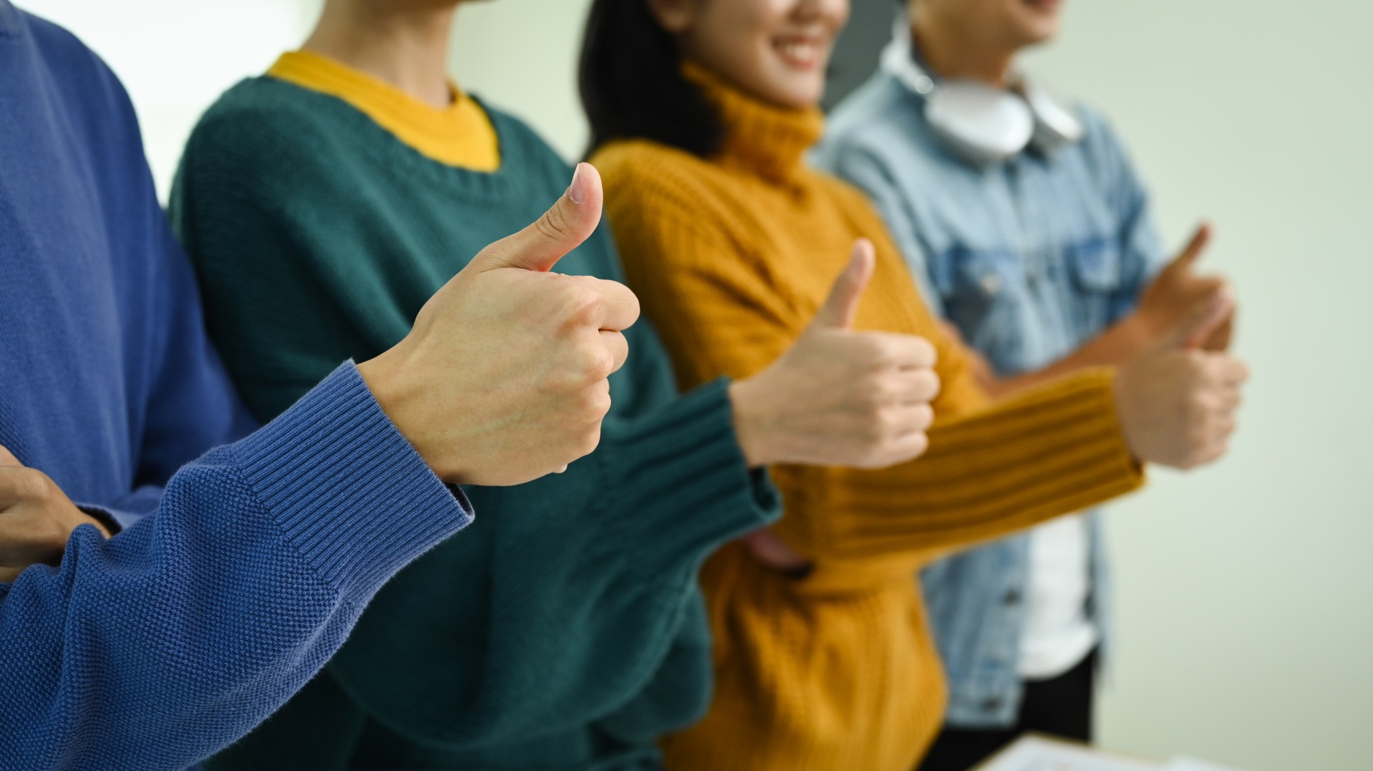 Group of setup businesspeople showing thumbs up, gesturing in the positive