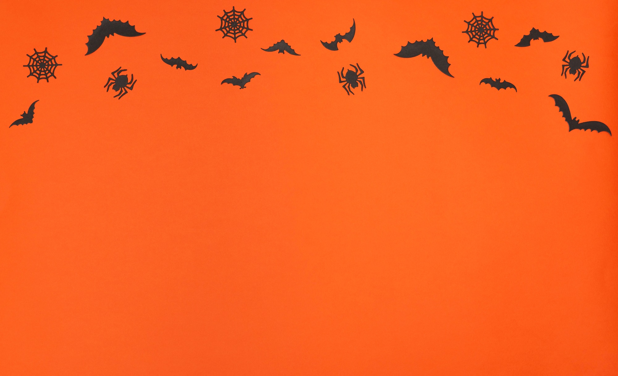 Halloween concept. Halloween decorations on orange background. Greeting or invitation card. Flat lay