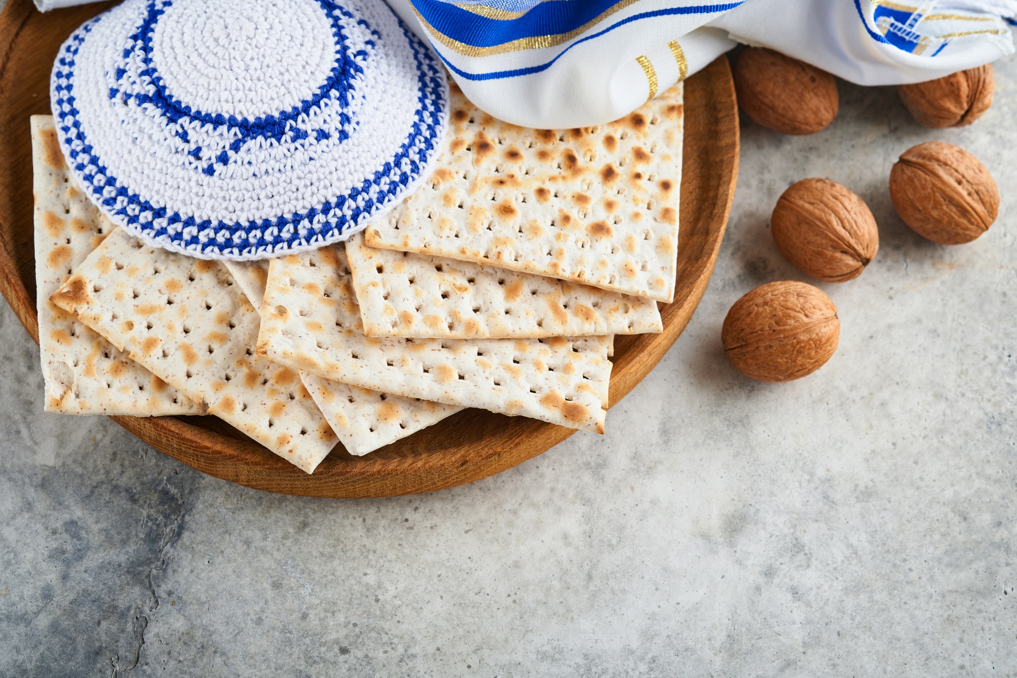 Passover celebration concept. Matzah, red kosher and walnut. Traditional ritual Jewish bread matzah,