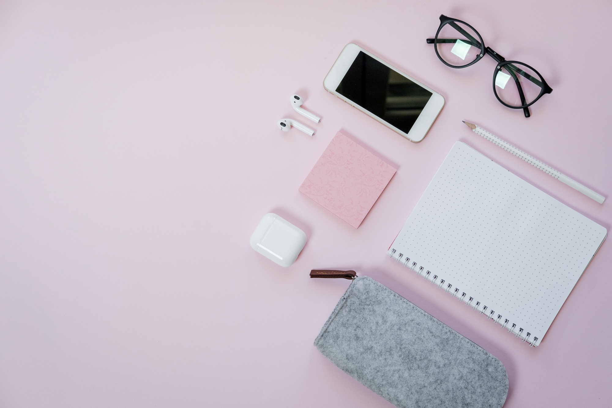 Phone and stationery on pink table. Business concept. Top view, flat lay