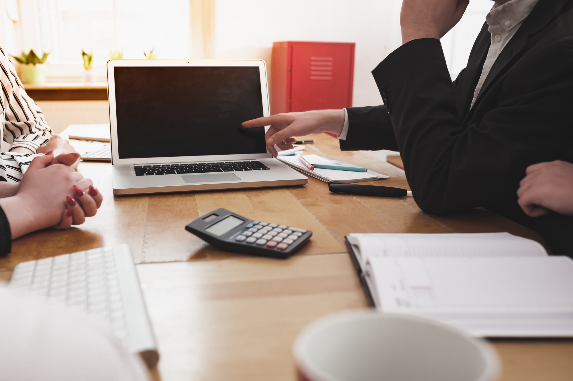Sales pitch or presentation on laptop computer in small offices business environment on desk