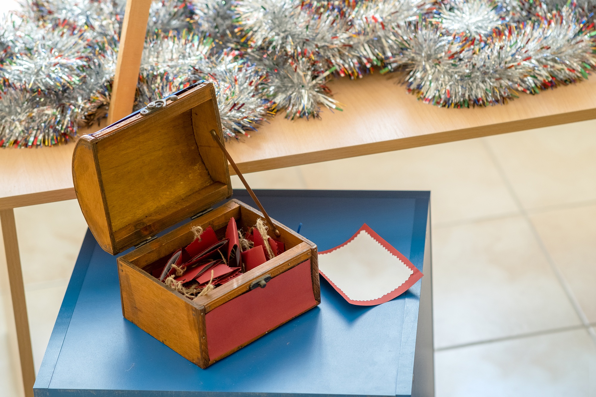 Small wooden gift box with red greeting cards inside