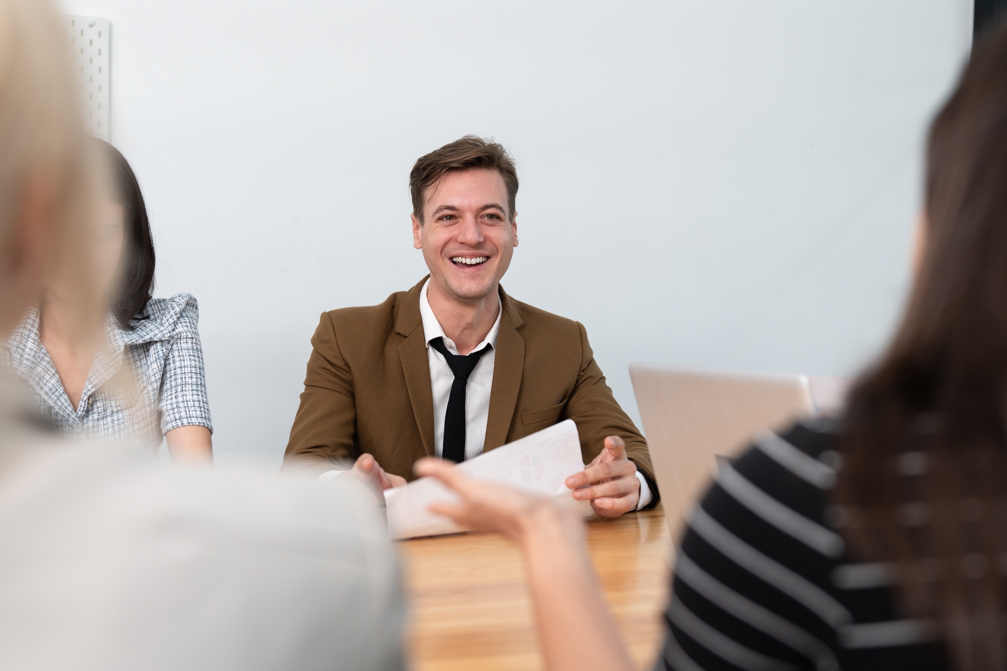 Smiling businessman meeting strategy planning business with marketing team colleague in meeting room