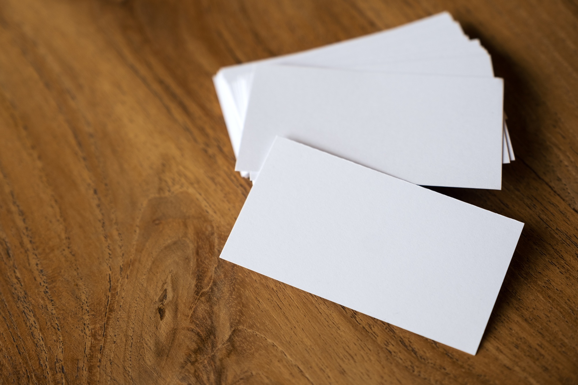 Stack of business card on wooden table background