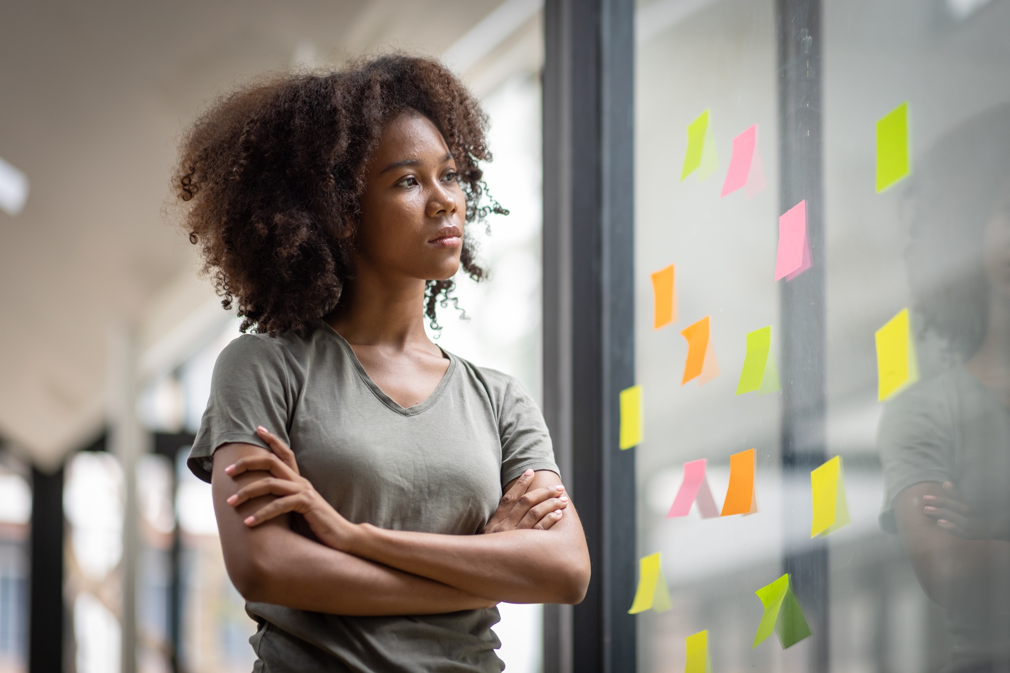 A black American african business woman in afro hairstyle planning in meeting at office and use post