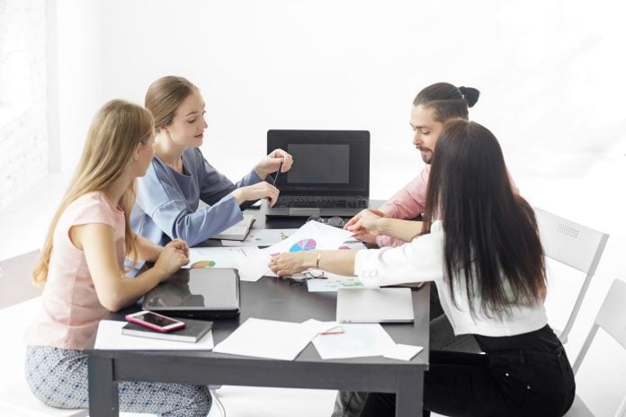 A group of colleagues communicate in the workplace. The concept of entrepreneurs, making money