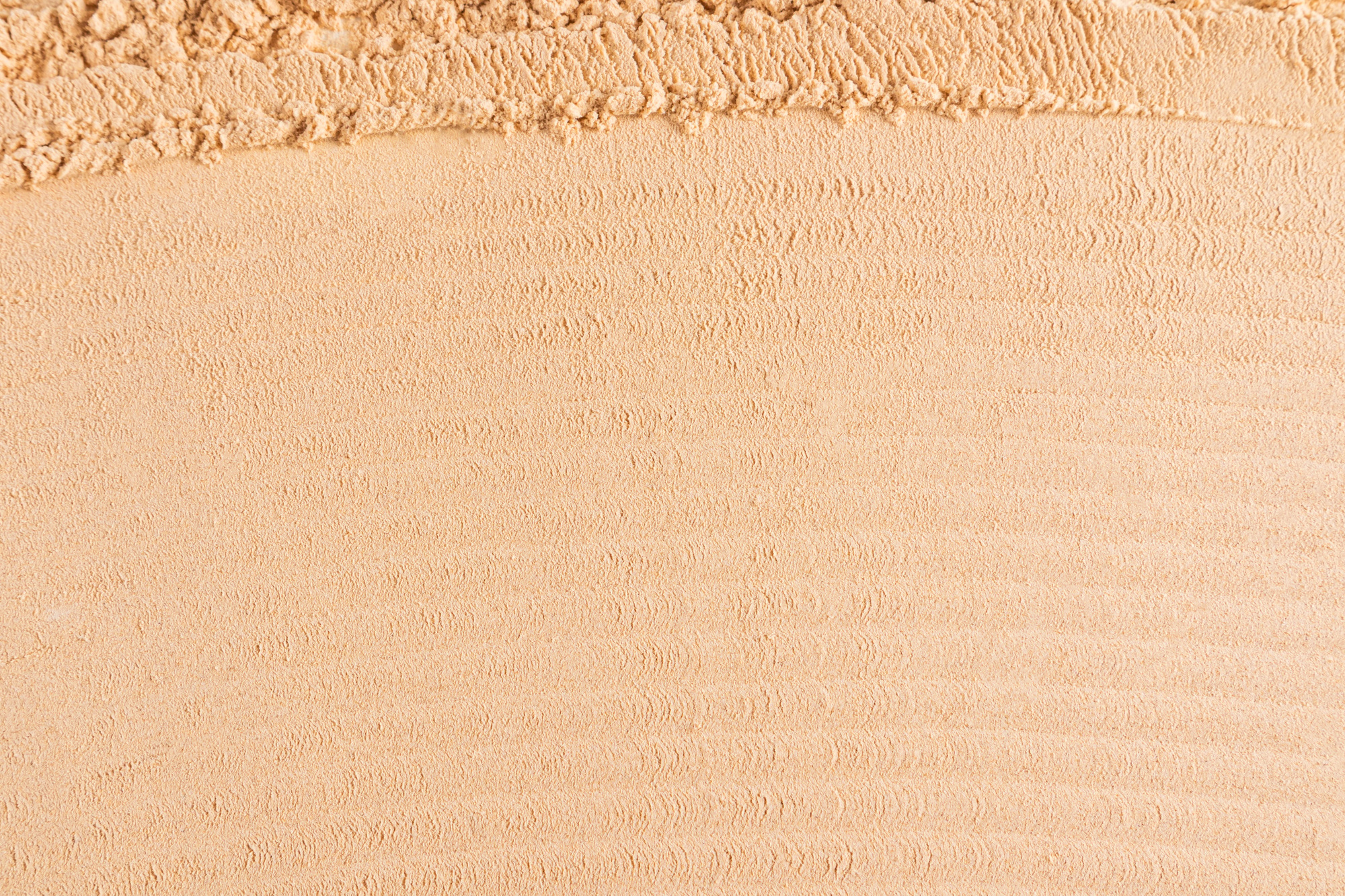 Abstract cosmetic background texture of loose powder in natural tone. Soft, parallel texture lines.