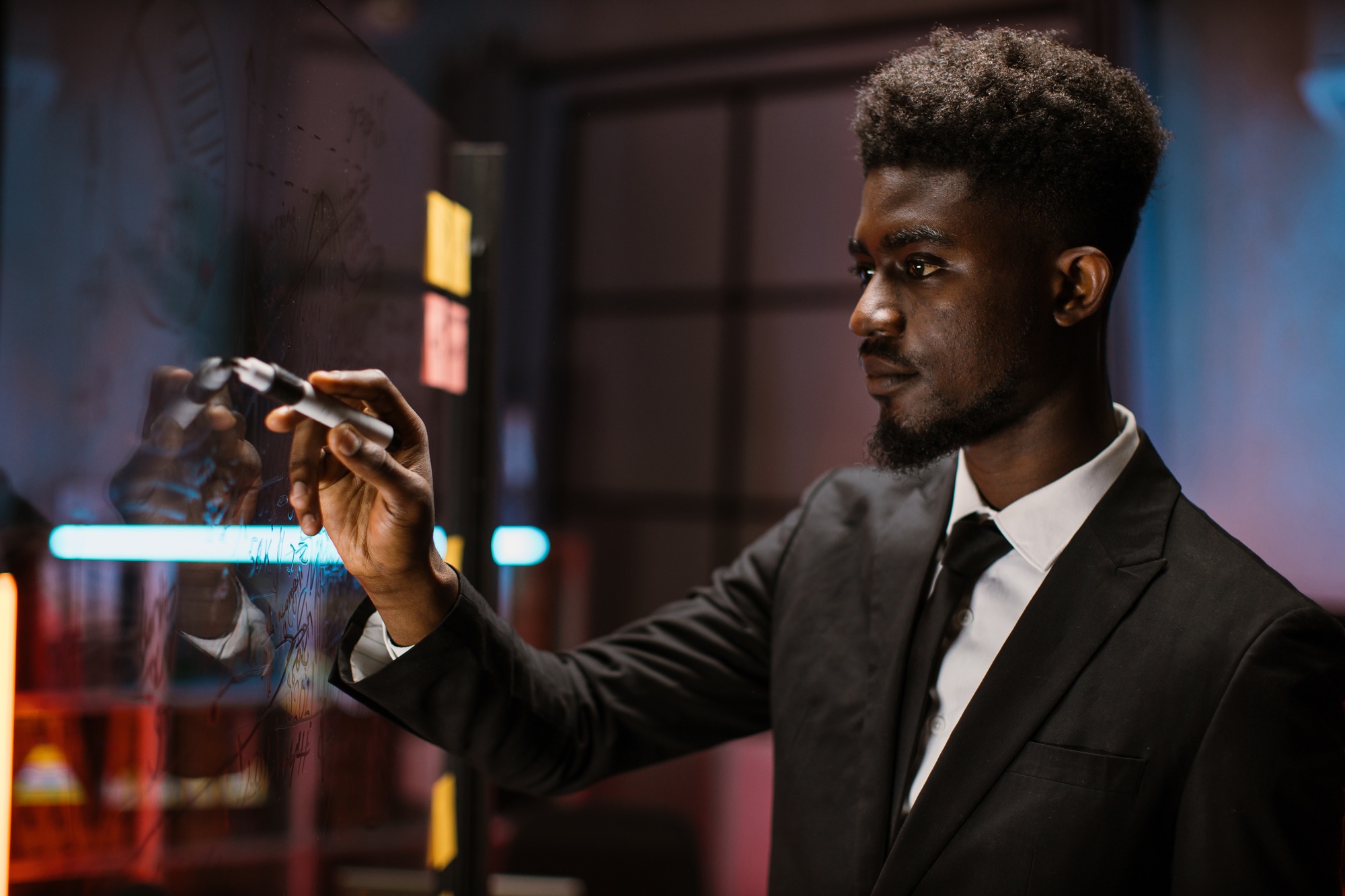 African american male professional expert, standing in front of glass wall with paper stickers