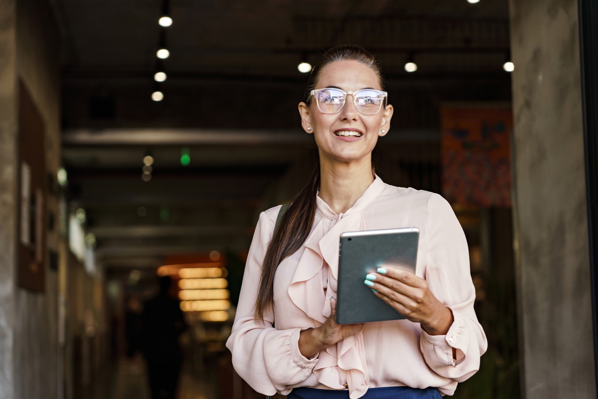 An office career, a financier is a confident woman using a tablet. In the business clothes