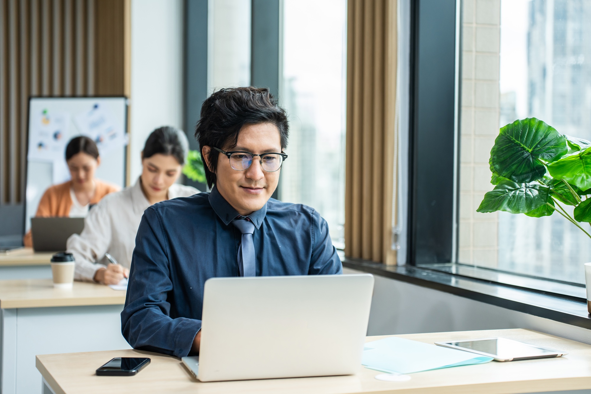 Asian young attractive businessman working in the office workplace.