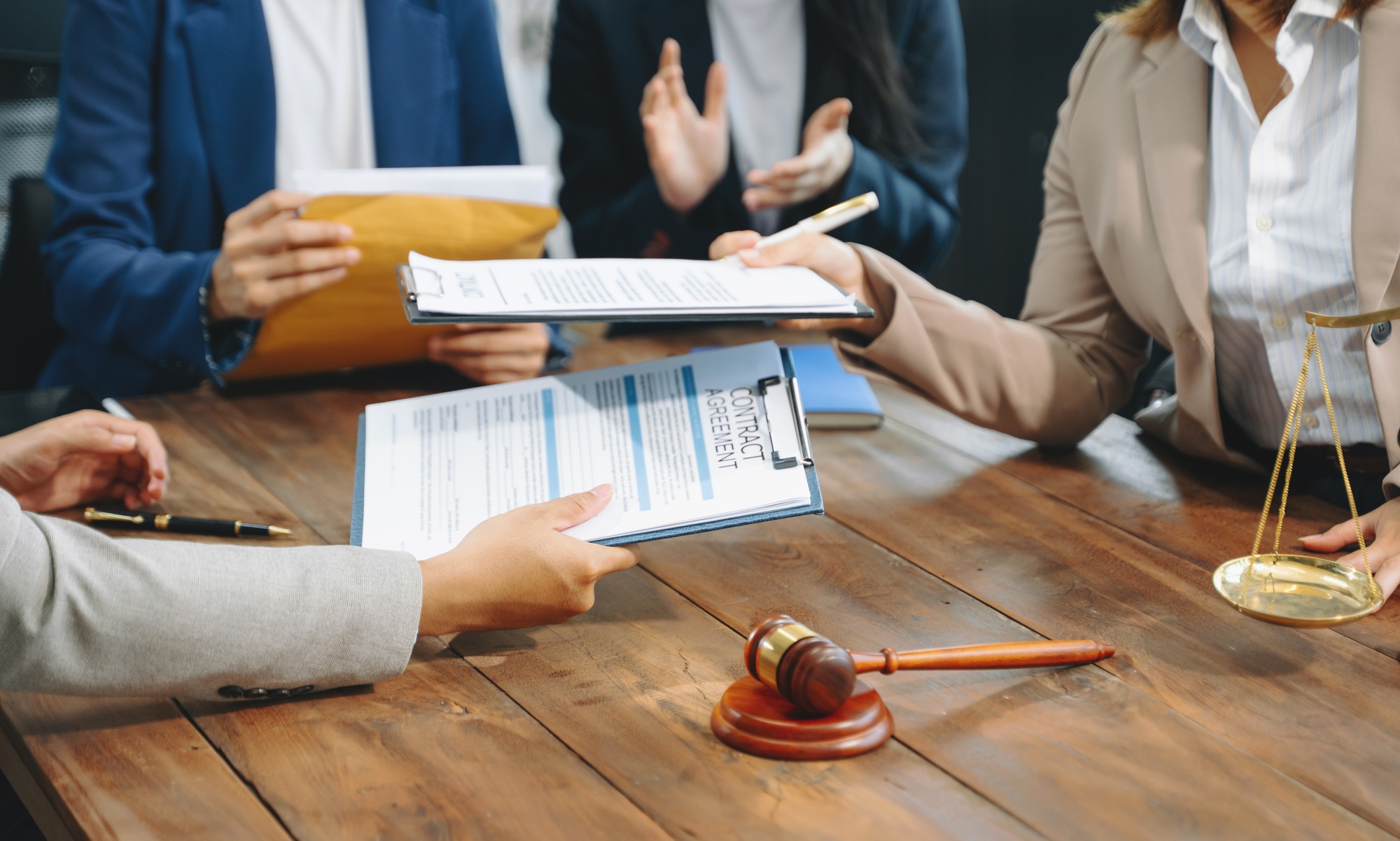 business people and lawyers discussing contract papers sitting at the table.