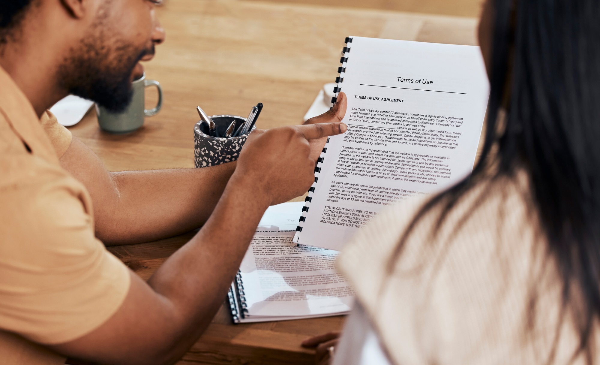 Business people, hands and pointing to policy document, contract or terms and conditions at the off