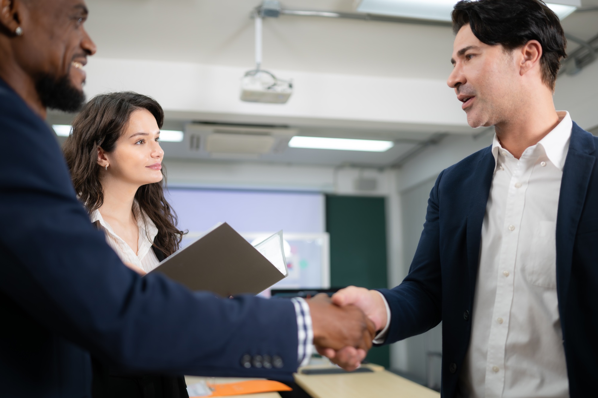 Business people shaking hands, finishing up a meeting. Shallow depth of field.