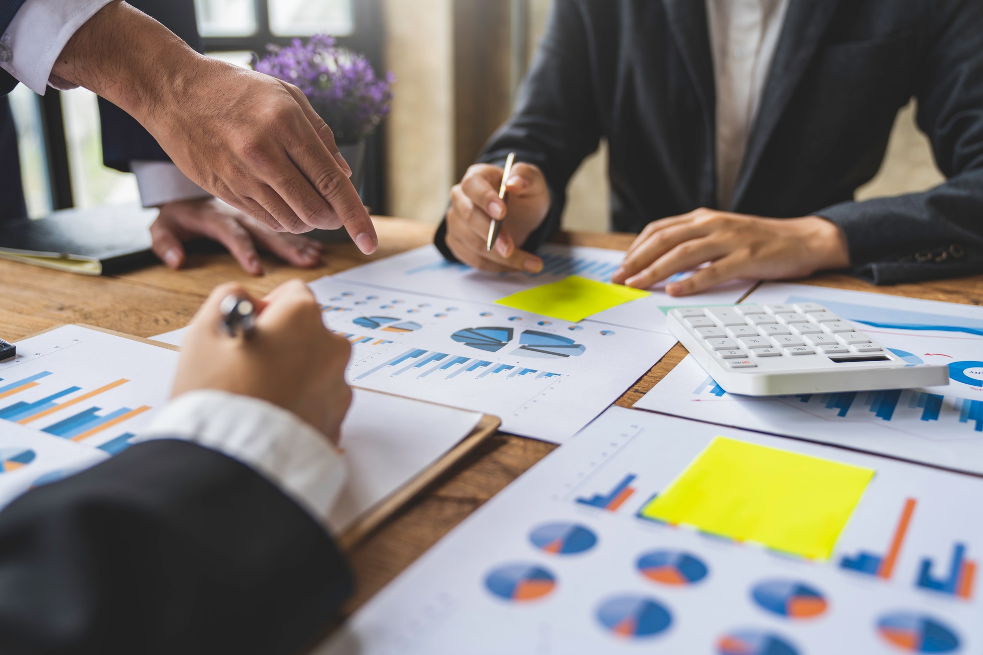 Business people using pen,tablet,notebook are planning a marketing plan to improve the quality of th