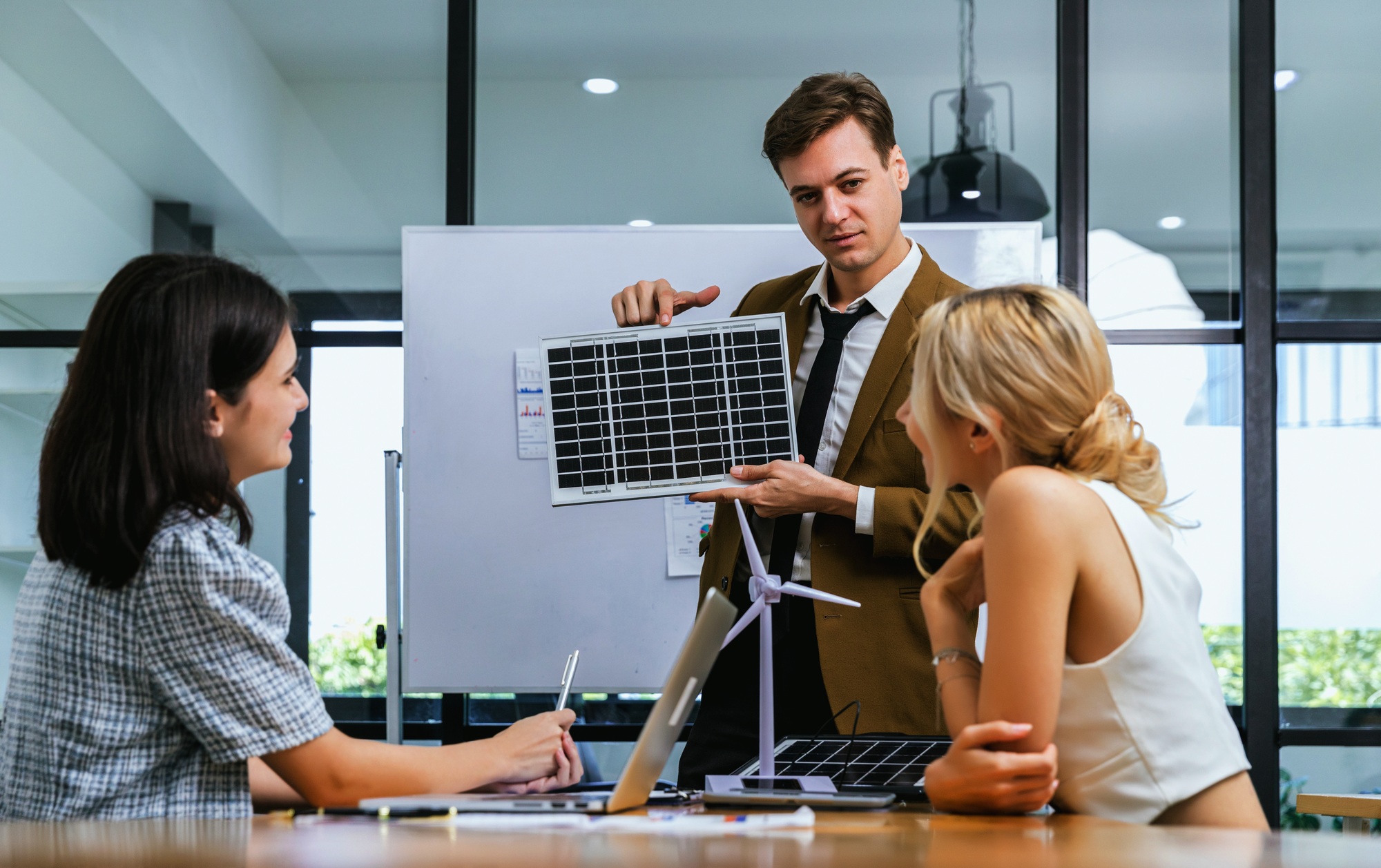 Business person meeting on solar cell panel technology. Business People Discussing Solar Power Envir