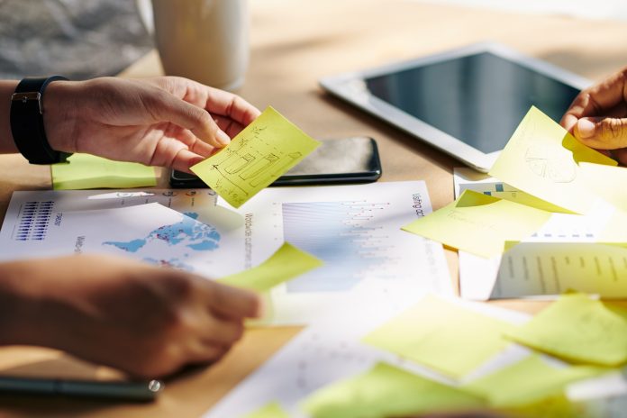 Business team checking stickers with ideas