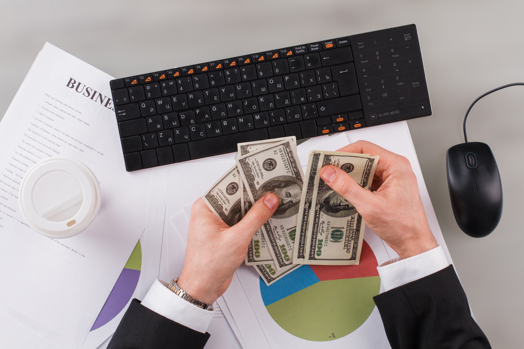 Businessman counting cash money in the office.