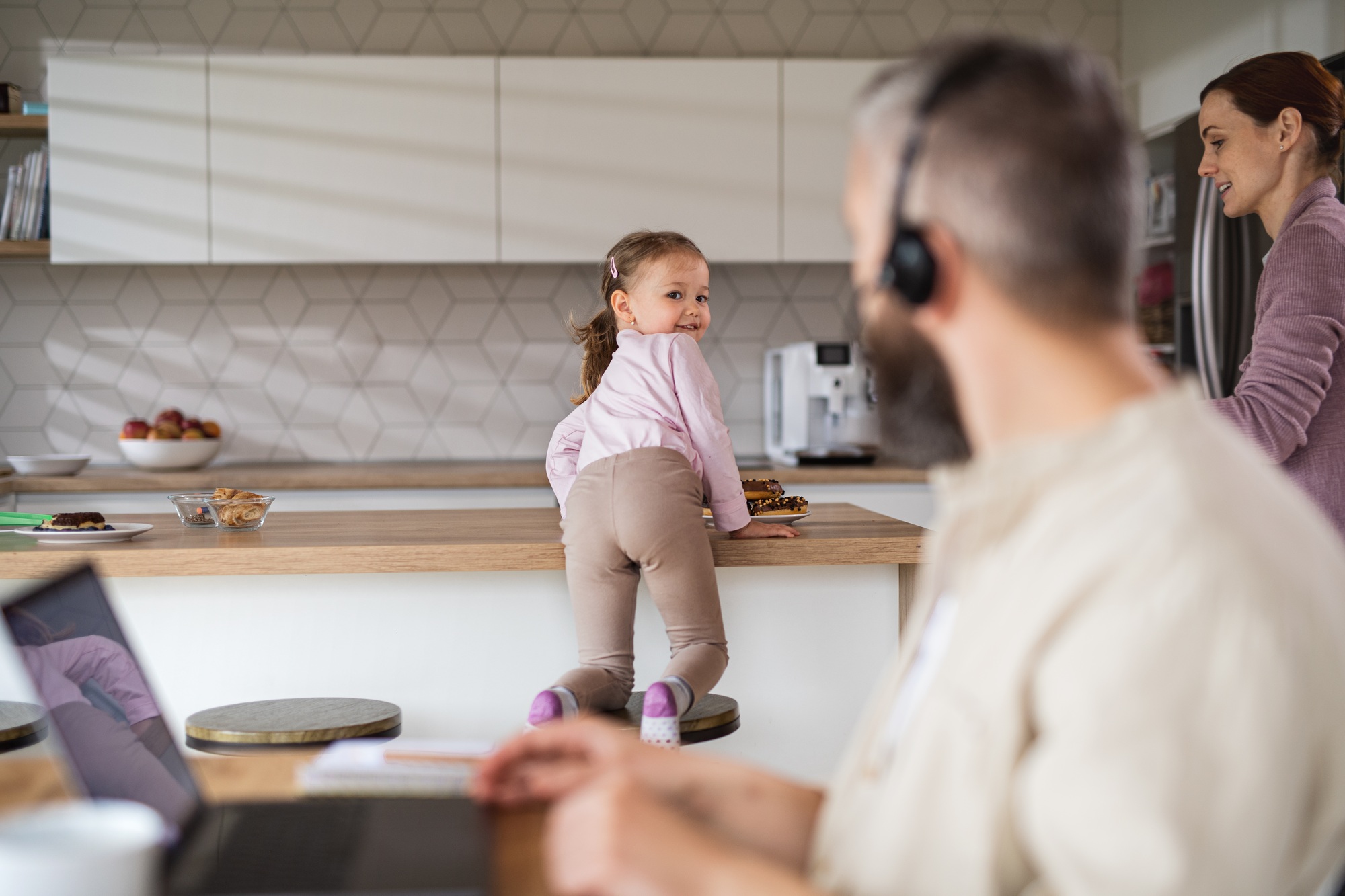 Businessman having video call indoors at home, everyday life and home office with child concept.