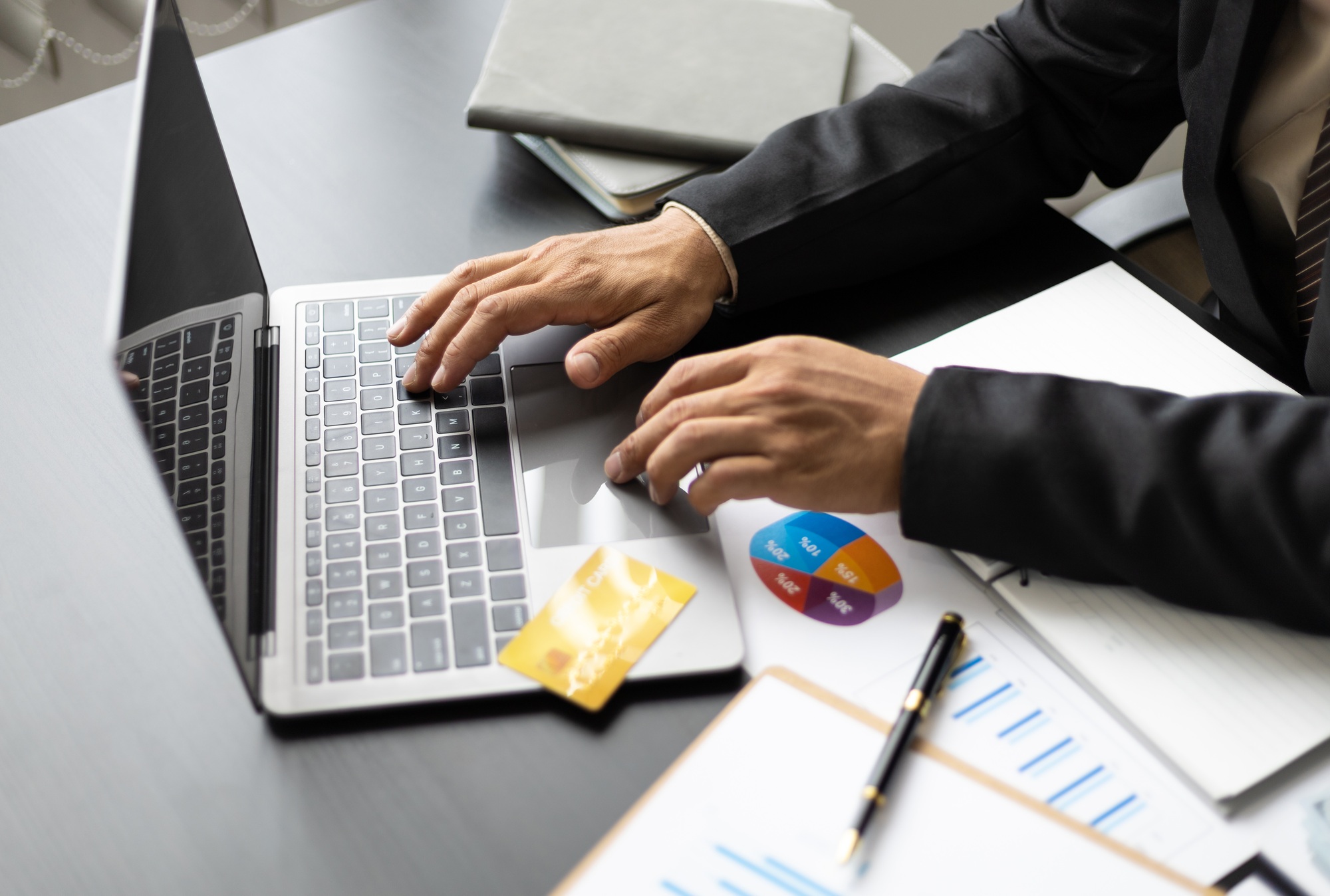 Businessman in office working on laptop analyzing finance and accounting.