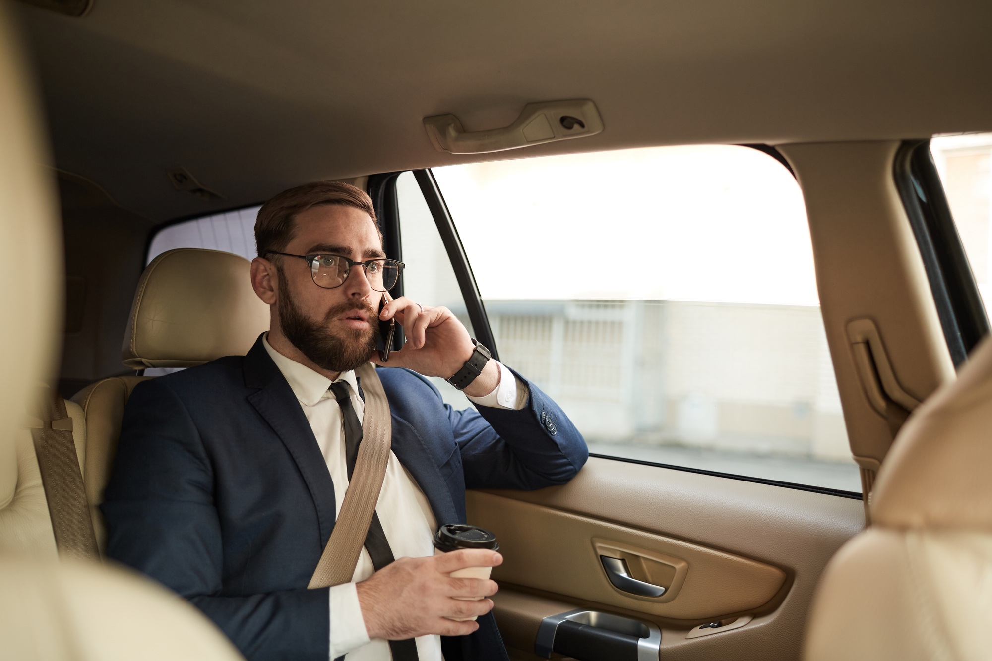 Businessman sitting like passenger in the car