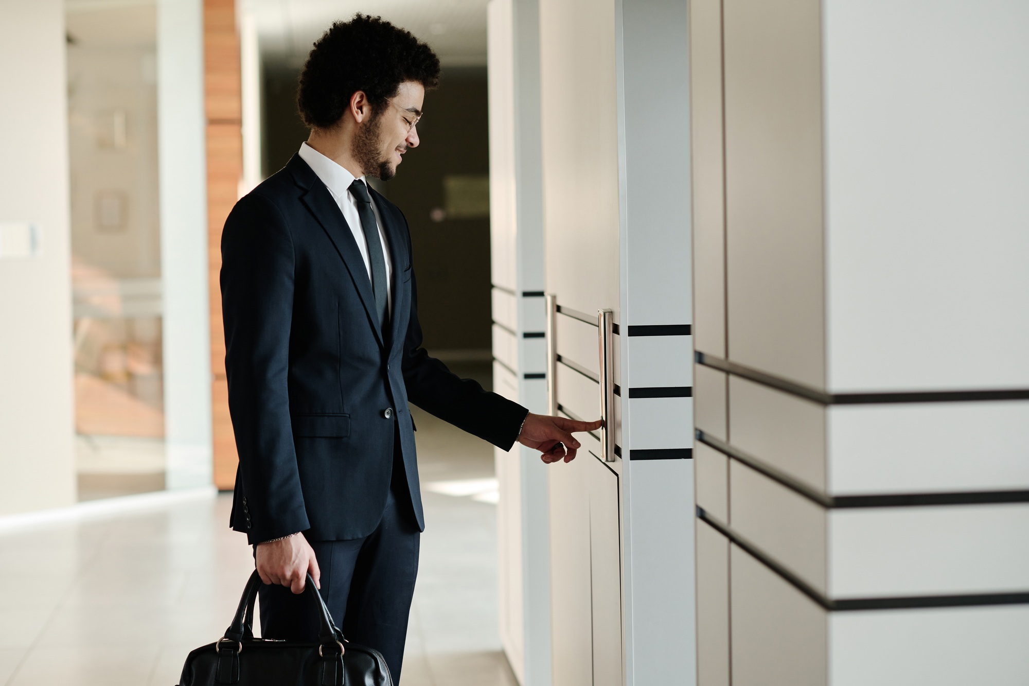 Businessman using elevator in office building